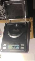 Photo of the gemstone on a precision scale showing weight of 1.48 carats.