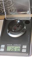 A single garnet gemstone on a precision digital scale showing a weight of 2.61 carats.
