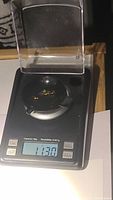 Four sapphires weighing approximately 1.13 carats total on a digital scale
