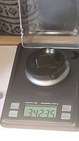 Digital scale showing gemstone weight of 34.235 carats