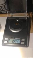 Photo of the Madeira citrine gemstone on a digital scale showing the weight of 6.535 carats.