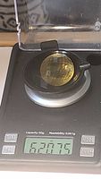 Photo of lemon citrine gemstone on a digital scale showing weight of 62.075 carats.