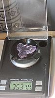 Natural amethyst eagle gemstone on digital scale showing 35.31 grams (approx 35 carats), confirming seller's weight.