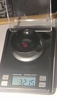 Ruby gemstone on digital scale indicating weight of 3.21 carats