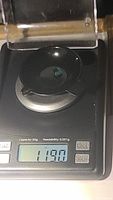 Emerald on digital scale showing weight of 1.19 carats.