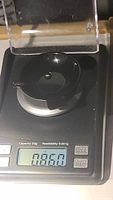Sapphire gemstone on scale showing weight of 0.86 carats