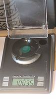 Gemstone on digital scale showing 10.035 carat weight