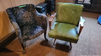Two chairs placed side by side on carpet against wood-paneled wall: vintage upholstered chair with floral fabric and retro green vinyl chair with wooden armrests.