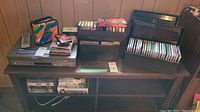 Samsung DVD/VHS player, cassette tapes, CDs, remote control and storage shelves
