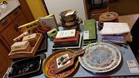 Overview of kitchen counters with vintage recipe card holders, trays, cheese board, glass baking dishes with lids, and books.