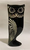 Blue and black Lucite owl sculpture with black and white Op Art pattern on wing and detailed dotted blue texture on body and head visible from front and side.