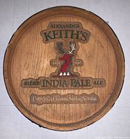 Front view of the wooden round plaque showing Alexander Keith's India Pale Ale logo and moose graphic.