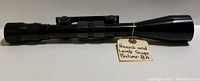 Side view of the Bausch and Lomb Balvar 8A rifle scope showing length and black metal body with adjustment ring and lens end visible.