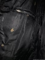 Close-up of interior lining showing several small worn holes and minor wear