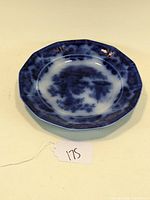 Top view of the 9 1/4 inch flow blue Sobraon pattern dinner plate showing the pattern and octagonal shape