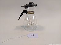 Mid-century vintage flameproof glass coffee pot with black plastic handle and lid, etched floral design on glass carafe