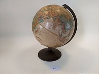 Full view of the 12in globe showing the Soviet Union area, mounted on a dark metal stand.