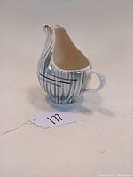 Photo of a ceramic creamer in Stetson Hiawatha pattern showing shape and exterior design
