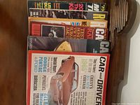 Lot showing spine view titles of magazines including Road and Track and Car and Driver from the 1960s.