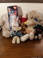 Lot of seven plush bears and bunnies, including the Ty Beanie Baby 'Glory' in packaging.