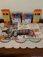 Photo shows entire lot with coloring books, two sets of Crayola markers, two boxes of Playskool colored pencils, and pencil sharpeners.