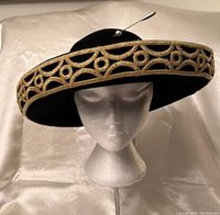 Black wool felt wide brim hat with gold embroidered trim and silver pin with pearl detail.