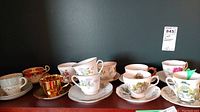 One shelf with 10 assorted tea cups and matching saucers, various floral and gold trimmed vintage designs