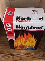 Front view of a box of Northland Fire Logs, showing brand name, flame graphic, and product details.