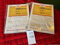 Photo shows two unopened packages of Saxon photo storage sheets for 4x6 photos, each containing 50 sheets with capacity for 400 photos.