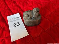 Front and side view of vintage carved buffalo horn sculpture showing detailed buffalo figure on an oval base.