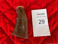 Overall carved buffalo horn sculpture showing natural horn texture and aged surface.