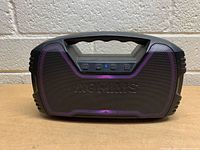 Front view showing Aomais Go Mini speaker with purple LED lights illuminating through the grille and control buttons on top under handle.
