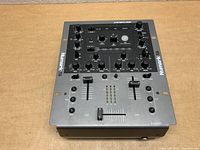 Front-facing view of the Numark X6 mixer on a wooden surface showing the control layout clearly.