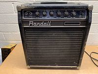 Front view of Randall guitar amplifier showing control panel with six knobs and two input jacks, Randall logo, and black grille.