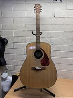 Full front view of the Yamaha acoustic guitar showing the body, sound hole, strings, and pickguard. The wood grain and finish are visible.