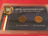 Front view of plastic display holding 1911 and 2011 Lincoln pennies, labeled as 100th Anniversary of American Coinage.