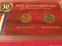 Front of the display showing the 1961 Lincoln Penny and 1961 Jefferson Nickel coins mounted in a red holder marked 50th Anniversary of American Coinage.