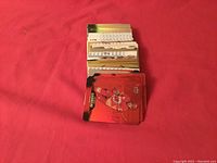 Photo showing a stack of about 90 Tim Hortons hockey card inserts on a red background.