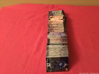 Stack of approximately 260 Tim Hortons hockey cards fanned out on a red background, showing front sides with player images mostly in blue and green uniforms.