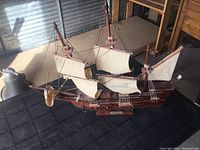 Overall angled view of the Mayflower wooden ship model showing full sails and rigging.