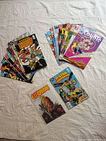 Comic books laid out on a light background showing covers and various titles.