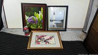 Lot of three framed pictures displayed: two photographs and one watercolor print. Soda can included for scale.