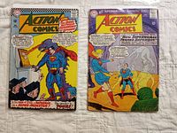 Two Superman Action Comics issues side by side on a white textured surface. Left comic is Action Comics 322, right is Action Comics 233. Both covers are colorful with silver age style art