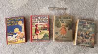 Four hardcover Honey Bunch books arranged side by side on carpet, with a pen above for scale.