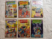 Photo showing six Silver Age comic books in protective sleeves, featuring Superman, Superboy, and the Legion of Super Heroes on the covers, titled Adventure Comics and Superboy from the 1960s.