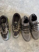 Top view of two pairs of size 9 golf shoes, Nike on the left and Adidas on the right.