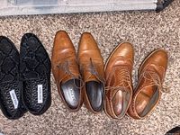Five pairs of men’s shoes including black slip-on loafers, two pairs of brown leather dress shoes including Aldo wingtip brogues, all size 9.