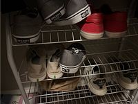 Shoe rack with shoes including Sperry and Vans brands