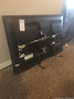 Back side of the 37-inch Vizio TV showing the area where a wall mount was attached or removed. Paint is chipped or damaged.