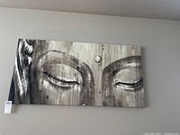 Full view of canvas wall art showcasing the Buddha face on a neutral woodgrain-style background